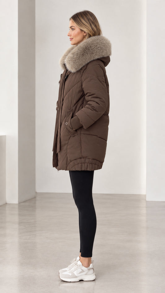 Side profile of model wearing brown hooded puffer coat and black leggings