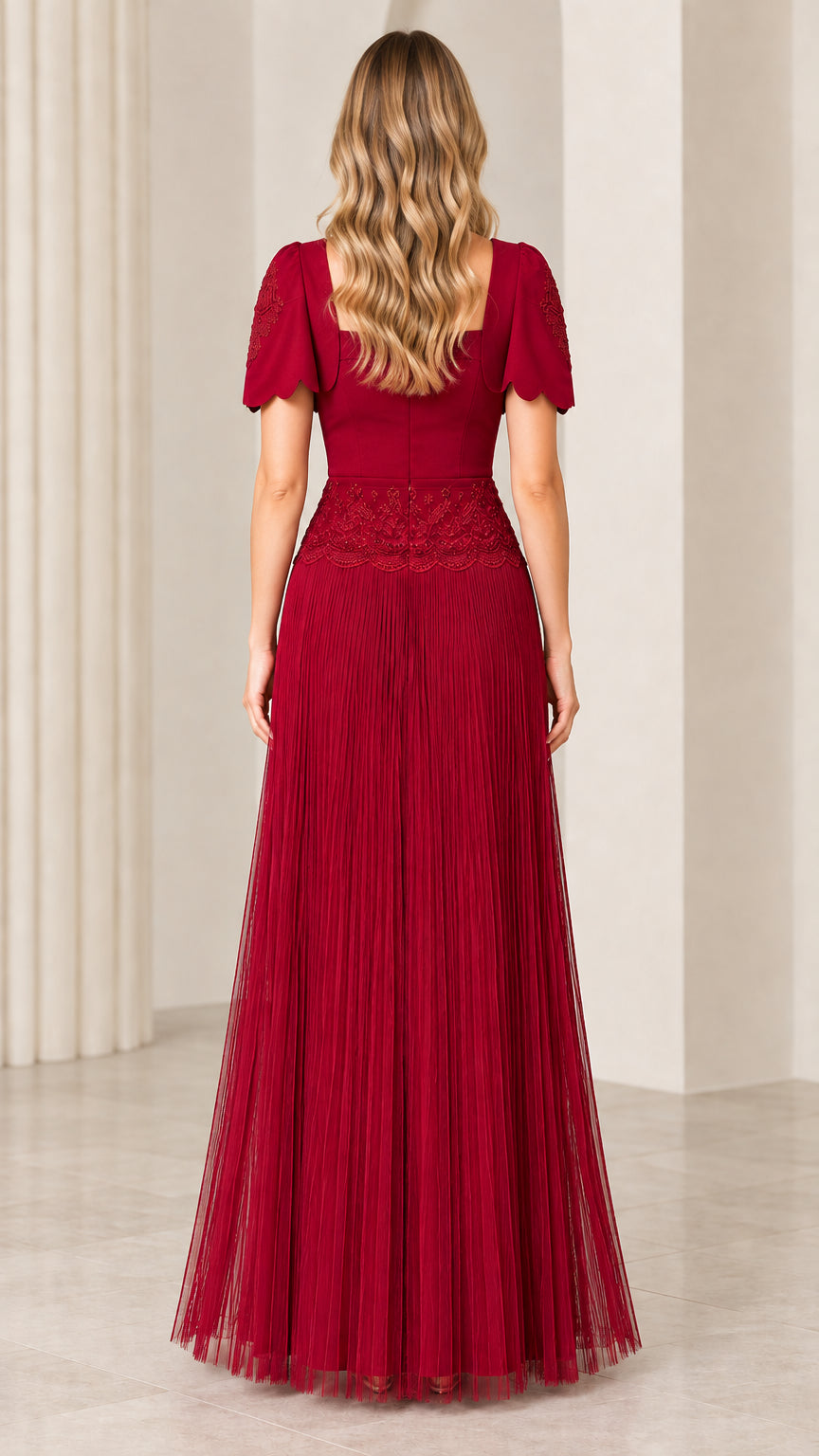 Back view of woman wearing burgundy square back pleated formal gown with bolero jacket