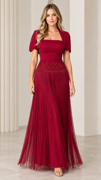 Front view of woman wearing burgundy square neck pleated maxi formal gown with embroidered bolero jacket