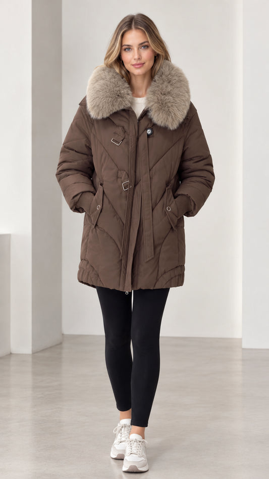Front view of model wearing brown mid-length quilted puffer parka with plush faux fur collar