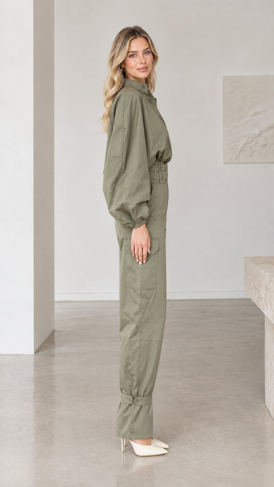 Side profile view of woman modeling olive green long sleeve utility jumpsuit