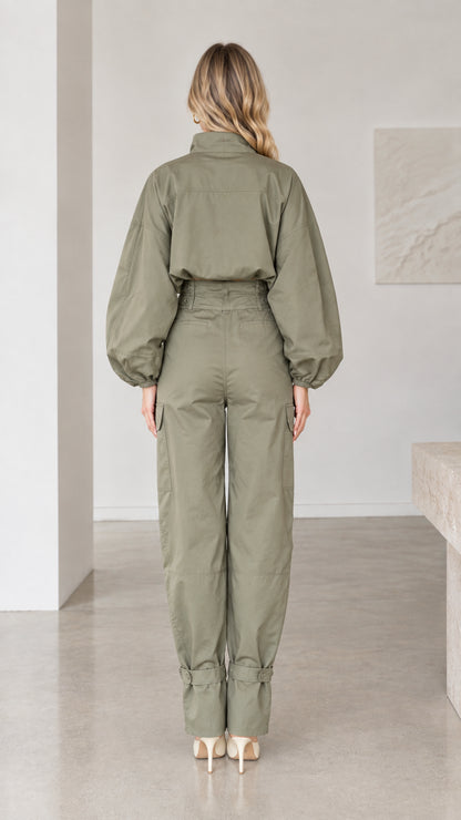 Back full-length view of olive green button-up cargo jumpsuit with tapered legs