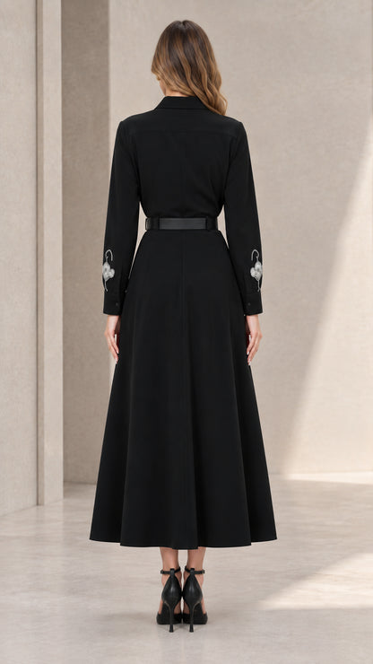 Back view of black long sleeve collared midi dress with belt