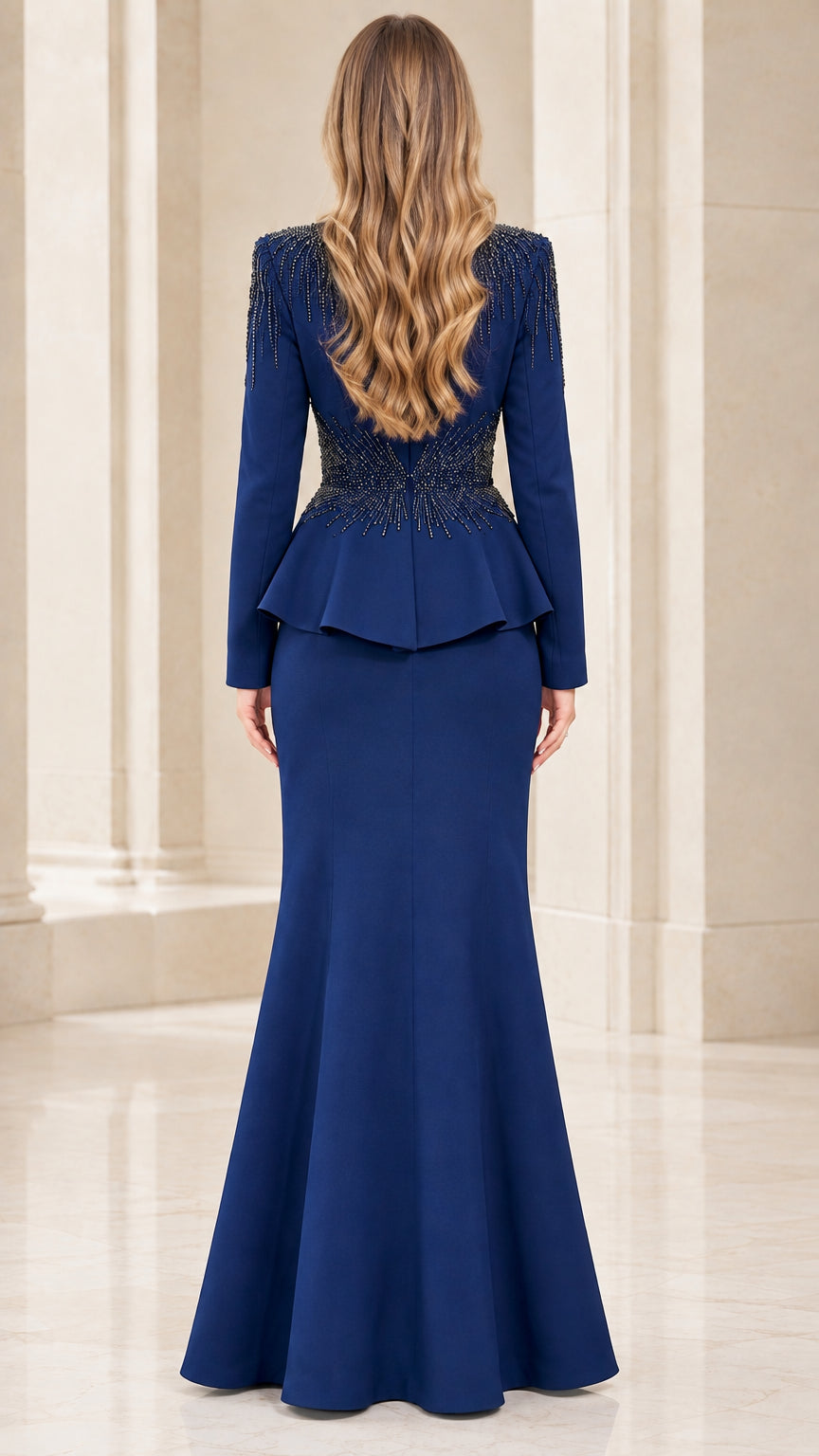 Back view of royal blue beaded evening gown showing peplum and flared hem