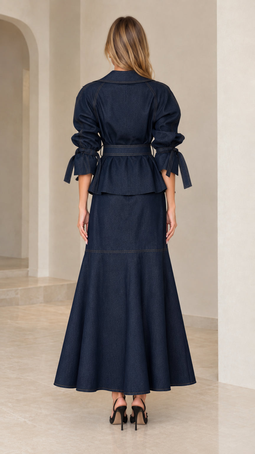 Back view of navy blue belted two-piece suit set showing back panel detailing and flared hem