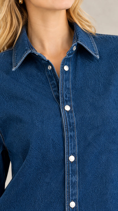 Close-up detail of the denim collar, placket, and snap-style buttons