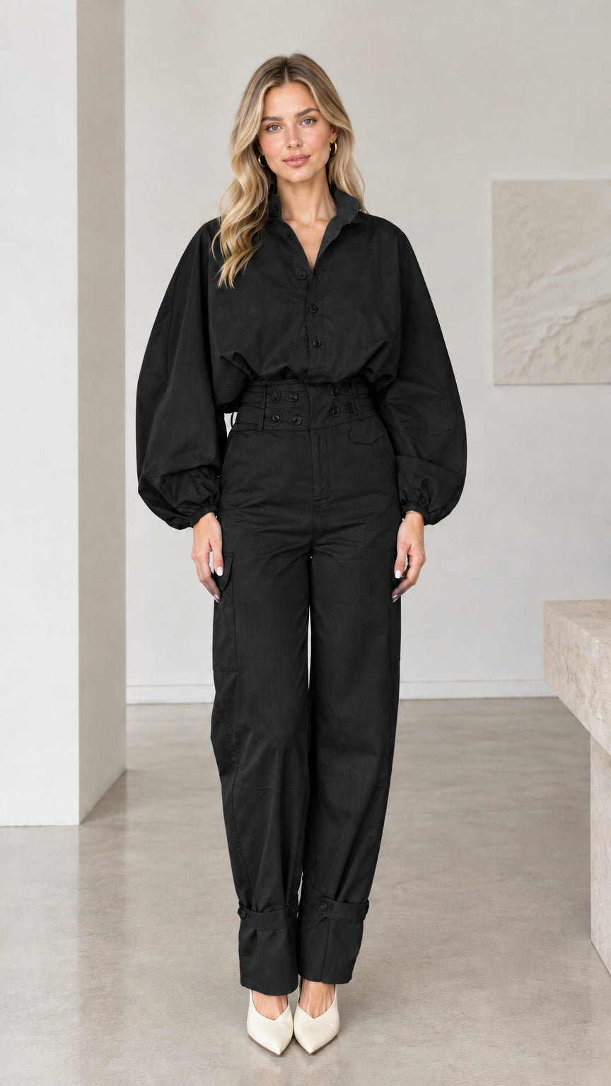 Front view of woman wearing classic black long sleeve utility cargo jumpsuit