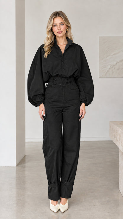 Front view of woman wearing classic black long sleeve utility cargo jumpsuit