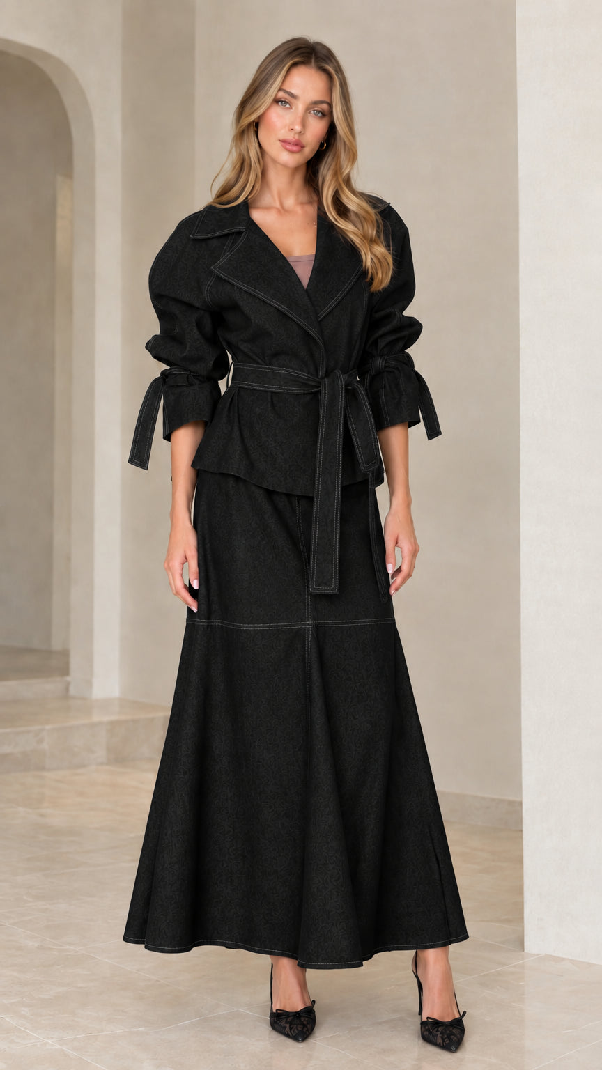 Front view of black two-piece belted jacket and long maxi skirt set
