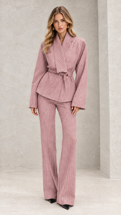 Front view of model wearing dusty pink pinstripe belted wrap suit set