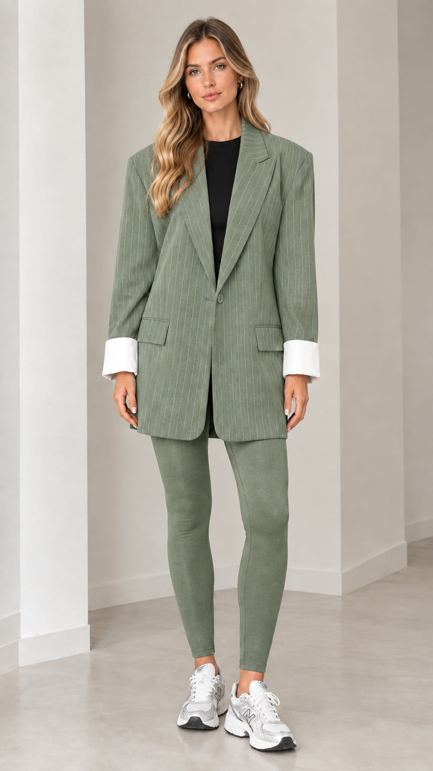 Front view of model wearing sage green pinstripe oversized blazer with matching leggings
