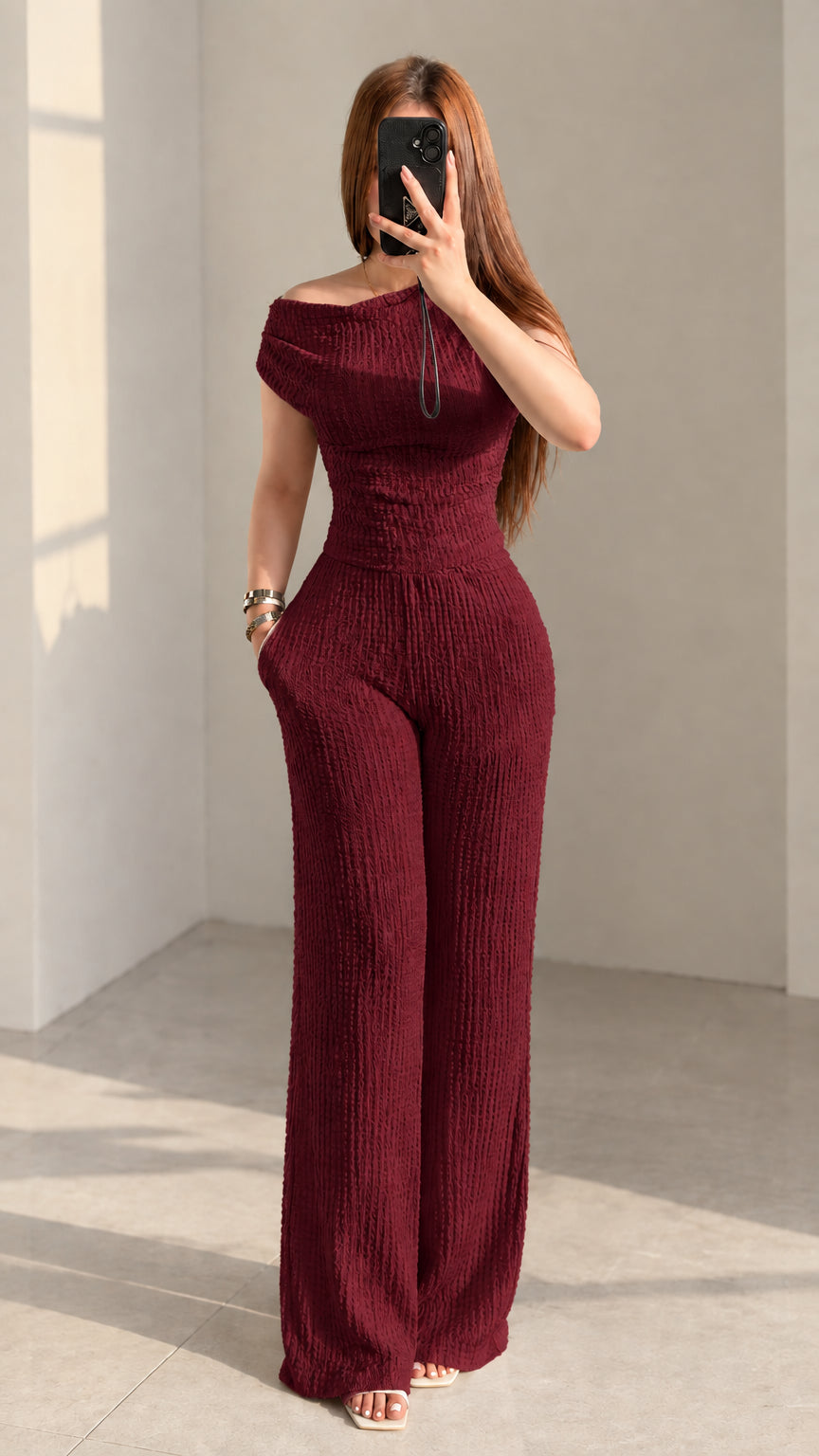 Front view of woman wearing burgundy wine red textured off-shoulder pant set