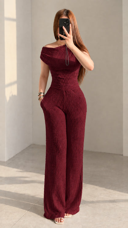 Front view of woman wearing burgundy wine red textured off-shoulder pant set