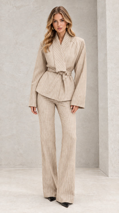 Front view of model wearing beige oatmeal pinstripe belted wrap pant suit