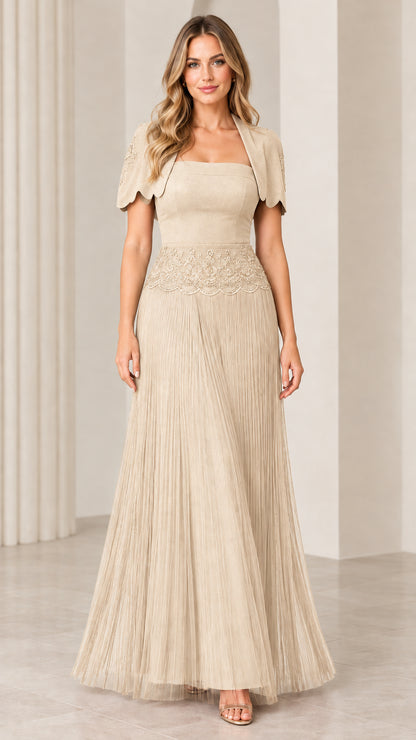 Front view of woman wearing champagne beige pleated maxi evening gown with bolero jacket